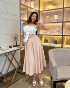 Woman in a store setting with shelves and products in the background