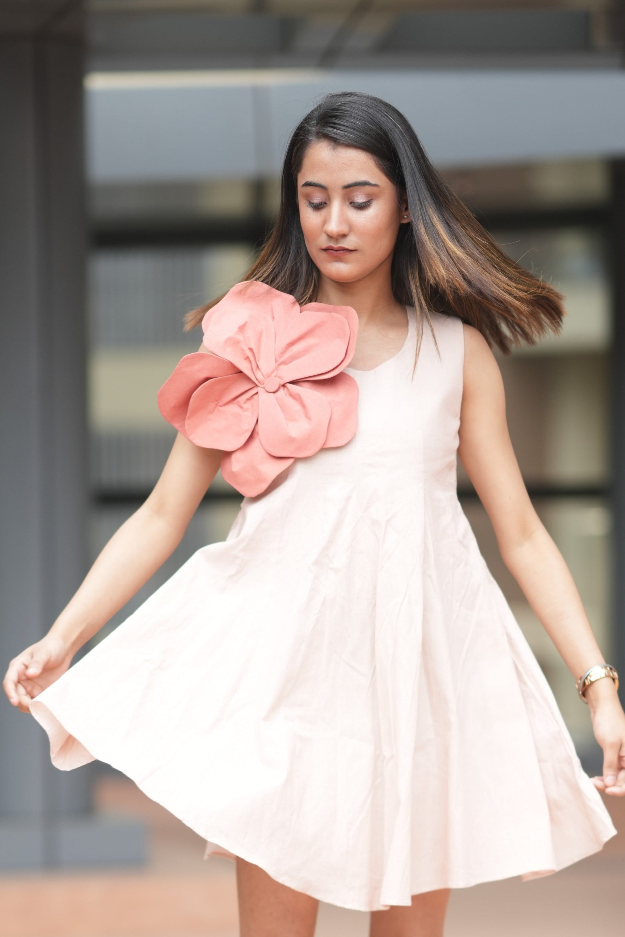 Sleeveless blush pink linen dress with a large red 3D fabric flower applique on the left shoulder